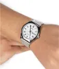 A person's wrist wearing a silver Casio watch with a white face. Produktbild-Vorschau