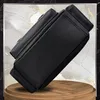 A black rucksack is shown from a side angle, resting on a wooden surface against a marbled background. Produktbild-Vorschau