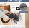 A person is putting a gray dog bed into a washing machine. A close-up of a zipper is shown in a circle. Produktbild-Vorschau