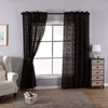 A living room scene with a window covered by dark patterned curtains, a chair, and a chest of drawers. Produktbild-Vorschau