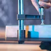 A hand is shown tightening a clamp on a metal object. Náhľad obrázku produktu