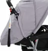 A close-up view of a stroller's canopy and handle. Náhled obrázku produktu