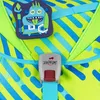 Close-up of a backpack strap with a monster charm and a buckle. Produktbild-Vorschau