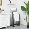 A bathroom scene with a towel rack, vanity, and plant. Produktbild-Vorschau