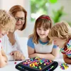 A family playing a board game with colorful balls. Produktbild-Vorschau