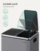 A close-up of a gray dual-compartment trash can with its lids open, showing a soft-close mechanism and icons indicating features. Produktbild-Vorschau