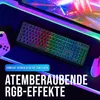 A gaming keyboard with RGB lighting on a desk with a controller and mouse, with a computer screen in the background. Produktbild-Vorschau