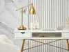 A modern desk with a gold lamp and decorative items. Voir les images du produit
