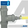 A close-up view of a plumbing fitting with a yellow hose attached. Podgląd zdjęcia produktu