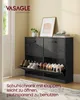 A black shoe cabinet with open doors displaying shoes, placed on a rug in a room. Produktbild-Vorschau
