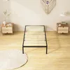 A bed frame with wooden slats is shown in the center of a room, with two nightstands on either side and a rug on the floor. Voir les images du produit