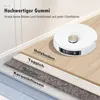 A robot vacuum cleaner is shown on a layered floor surface, illustrating its ability to function on different materials. Produktbild-Vorschau