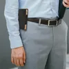 A man wearing a light blue dress shirt and gray dress pants, with a black leather belt and a black phone pouch attached to the belt. Náhled obrázku produktu