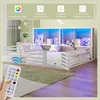 A child's bed with LED lighting and storage shelves, shown in a bedroom setting with a remote control in the foreground. Náhľad obrázku produktu
