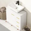 A white bathroom vanity with a white vessel sink and a black faucet. Produktbild-Vorschau