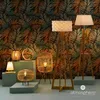 A collection of lamps displayed against a tropical leaf-patterned wallpaper. Podgląd zdjęcia produktu