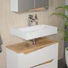 A modern bathroom vanity with a white sink and a wood-tone countertop. Náhled obrázku produktu