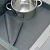 A pot is placed on a gray anti-slip mat inside a drawer. Voir les images du produit