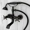 A close-up shot of a black retro-style bathtub faucet with bronze accents, mounted on a light gray wood-paneled wall. Anteprima dell’immagine prodotto