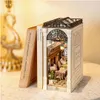 A miniature diorama of a cafe scene, designed to fit between books on a shelf. Podgląd zdjęcia produktu