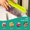 A person is pouring berries into a clear plastic container with a green lid. Below the container are four circular images showing sausages, soup, berries, and pizza. Produktbild-Vorschau