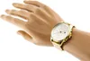 A gold Tommy Hilfiger watch on a mannequin's wrist against a white background. Produktbild-Vorschau