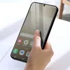A hand holding a smartphone with a screen protector applied. Náhľad obrázku produktu