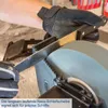 A gloved hand sharpens a knife on a wet grinding stone. Produktbild-Vorschau