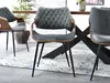 Dining chairs around a table in a modern dining room setting. Náhled obrázku produktu