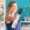A woman is holding a hair dryer in a bathroom setting. Náhled obrázku produktu
