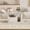 A modern living room scene with a white couch, coffee table, and rug. Produktbild-Vorschau