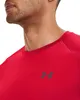 Close-up of a man wearing a red t-shirt with a dark grey logo on the chest. Náhľad obrázku produktu