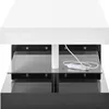 A close-up view of a modern coffee table with a white top and black base, featuring glass shelves and LED lighting. Anteprima dell’immagine prodotto