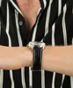 A close-up shot of a person's wrist wearing a watch. Podgląd zdjęcia produktu