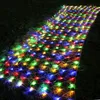 A path of colorful lights laid out on grass at night. Voir les images du produit