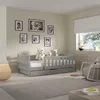 A child's bedroom with a bed, teddy bears, and framed pictures on the wall. Produktbild-Vorschau