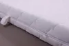 A close-up view of a white mattress cover with a zipper. Produktbild-Vorschau
