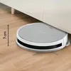 A robot vacuum cleaner is shown cleaning under a cabinet, with a measurement indicating its low profile. Anteprima dell’immagine prodotto