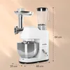 A white multi-functional kitchen appliance with a mixer bowl, meat grinder attachment, and blender jug, shown against a light orange and white gradient background with measurement indicators. Produktbild-Vorschau