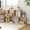 A wooden S-shaped bookshelf filled with books and decorative items, placed on a rug in a room with a window in the background. Podgląd zdjęcia produktu