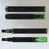 Four views of a black and green drawer slide mechanism against a light gray background. The top and third views show the slide in its retracted state, while the second and fourth views show it extended. Produktbild-Vorschau