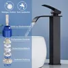 A black waterfall faucet is shown pouring water into a white basin, with a diagram of the faucet's internal components on the left. Produktbild-Vorschau