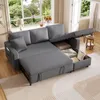 A grey sectional sofa with storage compartments open, showing blankets and pillows inside, in a well-lit room with a large window overlooking a garden. Produktbild-Vorschau