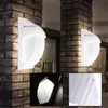 Two white outdoor wall lights mounted on a brick pillar, with close-up insets showing the light and a detail of the fixture. Náhľad obrázku produktu