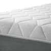 A close-up view of a mattress with a quilted pattern and a gray base. Produktbild-Vorschau