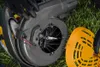 A close-up view of the internal components of a leaf blower, with gloved hands holding parts. Produktbild-Vorschau