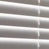 A close-up view of white horizontal blinds. Produktbild-Vorschau