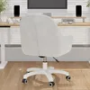 A white office chair is shown from the back in a home office setting with a desk and computer. Voir les images du produit