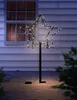 A lighted star decoration is placed on a patio in front of a house. Anteprima dell’immagine prodotto