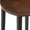 Close-up of a round wooden tabletop and black metal legs of a stool or small table. Náhled obrázku produktu